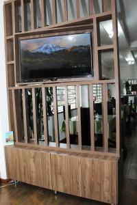 a large entertainment center with a flat screen tv in it at HOTEL TEUSAQUILLO BOUTIQUE BOGOTA in Bogotá
