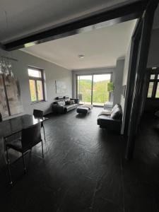 a living room with a couch and a table at Traumhafte Wohnung mit Neckarblick und Balkon in Eberbach