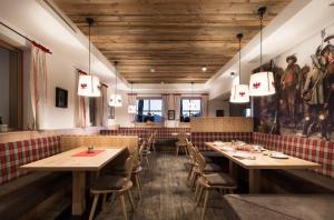 a restaurant with wooden ceilings and tables and chairs at Tanzalm Jerzens in Jerzens +32 photos