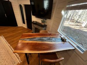 a wooden table in a room with a window at Romantic Gazebo Cottage w Hot Tub & Pond in Marshallville +42 photos