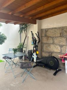 a room with a table and a treadmill and a table at JM Alojamento local no Porto in Porto