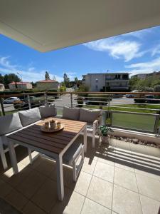 a patio with a table and chairs on a balcony at Appartement 2 chambres dans résidence avec piscine et parking in La Ciotat