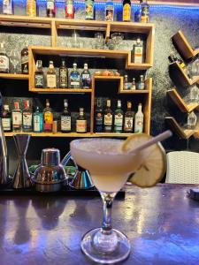 a drink in a martini glass sitting on a bar at Zhaya's Beach & Cottages in El Nido