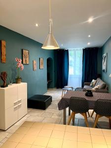 a living room with a dining table and a kitchen at appartement Breil sur Roya centre in Breil-sur-Roya