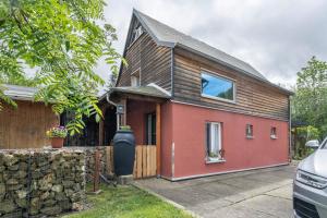 a home with a red house with a stone wall at Chalet Kunterbunt in Langenwetzendorf