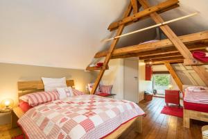 a bedroom with a large bed and wooden beams at Chalet Kunterbunt in Langenwetzendorf