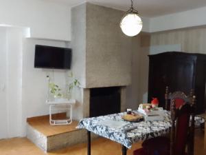 a living room with a table and a fireplace at Depto en Trelew in Trelew