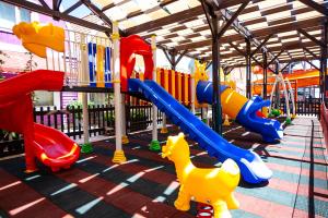 a playground with a slide and a slideintend at Orange County Kemer Family Only in Kemer