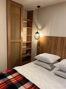 a bedroom with a bed and a lamp and shelves at Best Holiday Port Grimaud in Grimaud