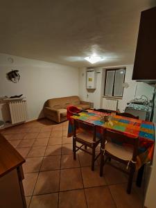 a living room with a table and a couch at Appartamento centro storico in Ornica