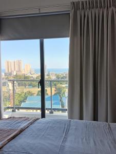 a bedroom with a bed and a large window at Rental house Santo Domingo in Santo Domingo