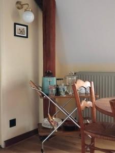 a kitchen with a table and a table and chairs at Le logis de Bodard in Chinon