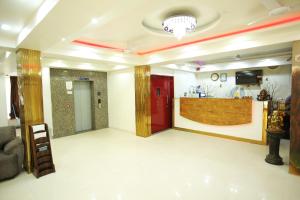 a lobby with a red door and a counter at Hotel Aman Inn With early check in in New Delhi