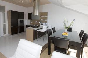 a kitchen and dining room with a table and chairs at Apartments Gudelj in Podgora