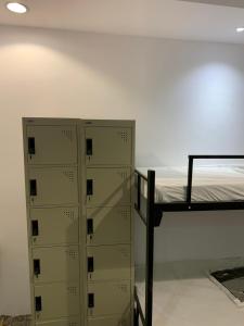 a group of lockers in a room with a bed at The Traveler Hostel in Riyadh