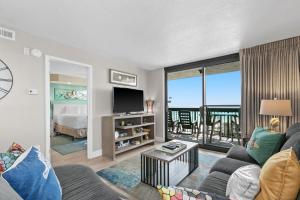 a living room with a couch and a tv at SunDestin Resort Unit 1018 in Destin