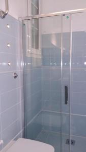 a bathroom with a glass shower and a toilet at Casa Per 2 in Porto Santo Stefano