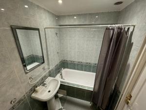 La salle de bains est pourvue d'un lavabo, d'une baignoire et de toilettes. dans l'établissement Dwór Szczepańskich, à Woszczyce