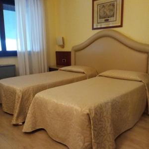 Postel nebo postele na pokoji v ubytování Hotel City Legnano