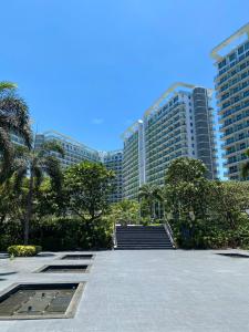 a group of tall buildings in a city with stairs at The Bahamas & Maldives Suites at Azure Residences near Manila Airport in Manila