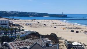 a beach with a bunch of people on it at Casa Alberto in Portimão