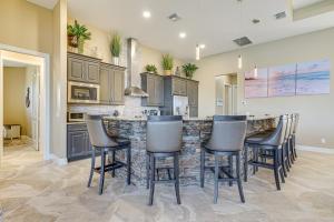 a kitchen with a bar with stools at Lakefront Home with Private Dock in Cape Coral! in Matlacha