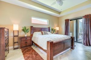 a bedroom with a bed and a dresser and a window at Lakefront Home with Private Dock in Cape Coral! in Matlacha +34 photos