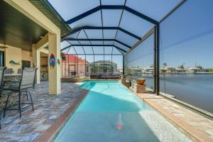 an indoor swimming pool with a large glass ceiling at Cape Coral Home on Lake with Heated Pool and Hot Tub! in Matlacha