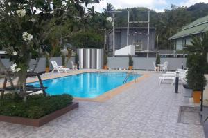 a pool with chairs and a table and a building at Perfect Studio your holiday in Krabi Condo & Apartment in Ban Khlong Haeng