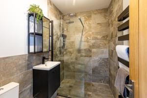 a bathroom with a shower and a sink at Midford Hideaway in Bath