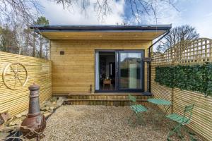 a small wooden house with a table and chairs at Midford Hideaway in Bath