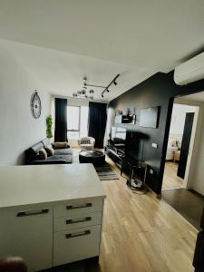 a living room with a couch and a table at Fully Furnished 1 Plus 1 Bedroom Suite Apartment in Esenyurt