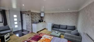 a living room with a couch and a kitchen at Studio Alex in Ghent
