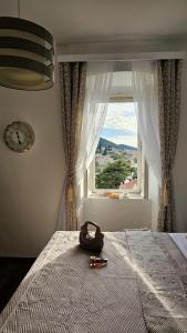 a bedroom with a bed with a large window at Apartments Miljas 2 in Dubrovnik