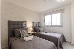 Postel nebo postele na pokoji v ubytování Contemporary Apartment In Boggiani Avenue