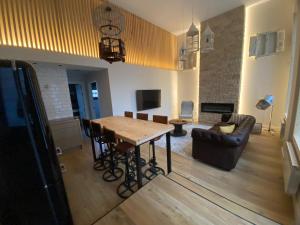 a living room with a wooden table and a couch at Cornelia Suites 03 in Santander