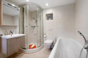 a bathroom with a shower and a toilet and a tub at Ferienwohnungen 'am Waldrand' in Hartmannsbach +54 photos