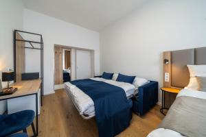 1 dormitorio con cama y escritorio con espejo en Hotel LEON en Praga