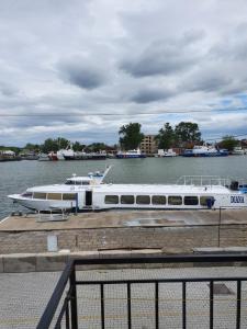 a white boat is docked at a dock at Casa Amiral in Sulina +29 photos