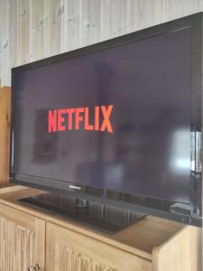 a television screen with the netflix sign on it at Reinunga Eco Hytta - Mountain lodge near Myrdal accessible only by train or bike in Myrdal +45 photos