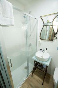 a bathroom with a shower and a sink at The Cave in Naples +21 photos