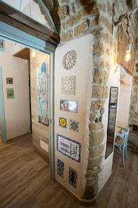 a room with a stone wall with art on it at The Cave in Naples