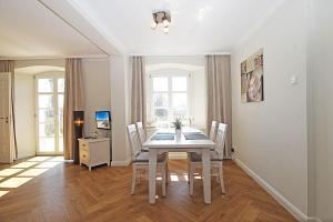 a dining room with a table and chairs at Traumurlaub im Schloss Hohen Niendorf in Bastorf +7 photos