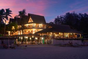 a large building on the beach at night at Vaayu Kula mandrem in Mandrem