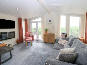 a living room with a couch and a tv at Plot 32 in Carlisle