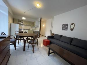 a living room with a couch and a table at Appartamento bilocale centralissimo 013 in Pinzolo