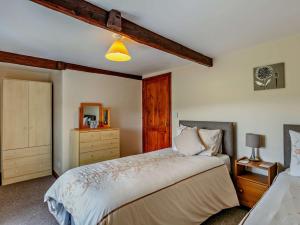 a bedroom with a large bed and a dresser at 2 Bed in Chulmleigh DARTG in Chulmleigh