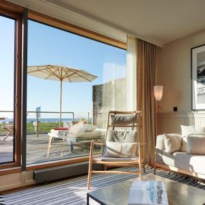 a living room with a view of the ocean at Hotel Haus am Meer in Norderney