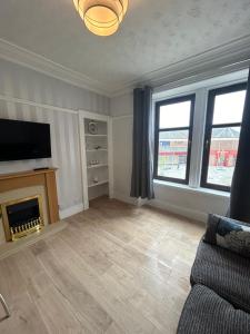 a living room with a couch and a fireplace at Class Apartments in Peterhead +15 photos