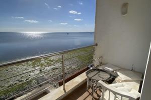 a balcony with a view of the ocean at Dar Douja / Grandview Waterfront Duplex / Four seasons in Sfax